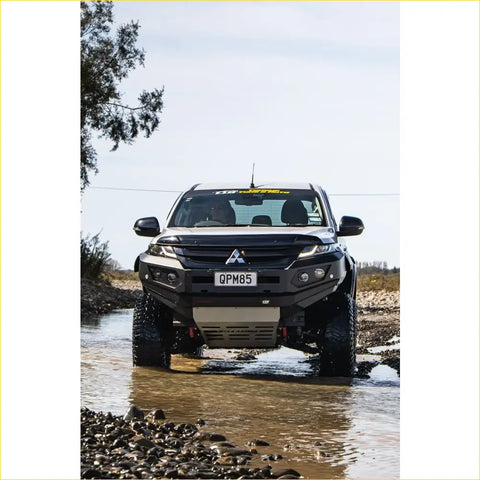Black mitsubishi triton ute with rockarmor gt hoopless steel bullbar and rugged offroad 4wd tires