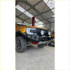 Black rugged steel rockarmor gt hoopless bullbar with led lights and red tow hooks on yellow ford ranger ute for 4wd offroad