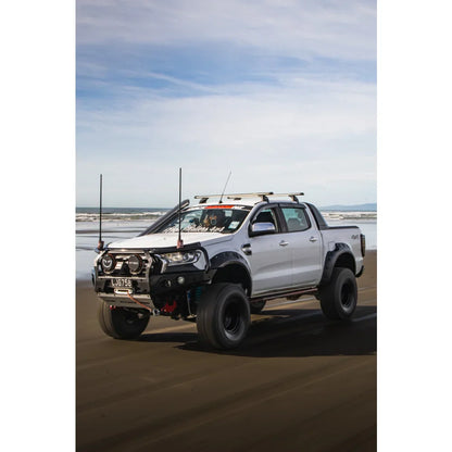 Modified white pickup truck with hoop bullbar, driving lights, and synthetic winch rope