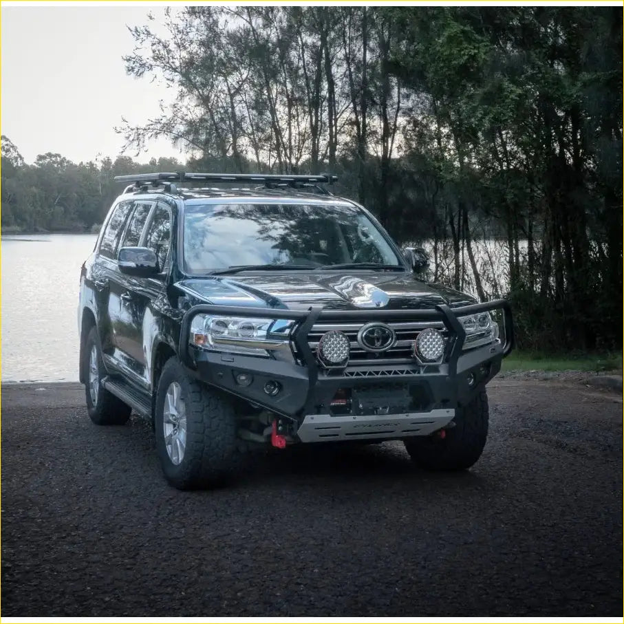 Black toyota land cruiser 300 with rugged steel rockarmor gt hoop bullbar and roof rack for tough off-road use