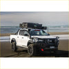 White toyota hilux 4wd ute with black steel rockarmor gt hoop bullbar and rooftop tent for offroad adventures