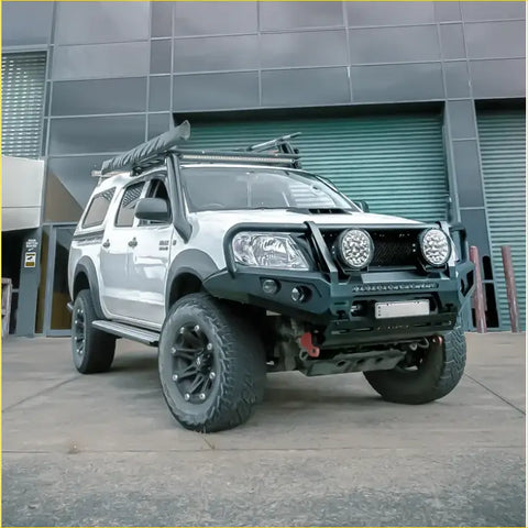 Silver toyota hilux ute with black steel rockarmor gt bullbar and rugged offroad tires for 4wd use