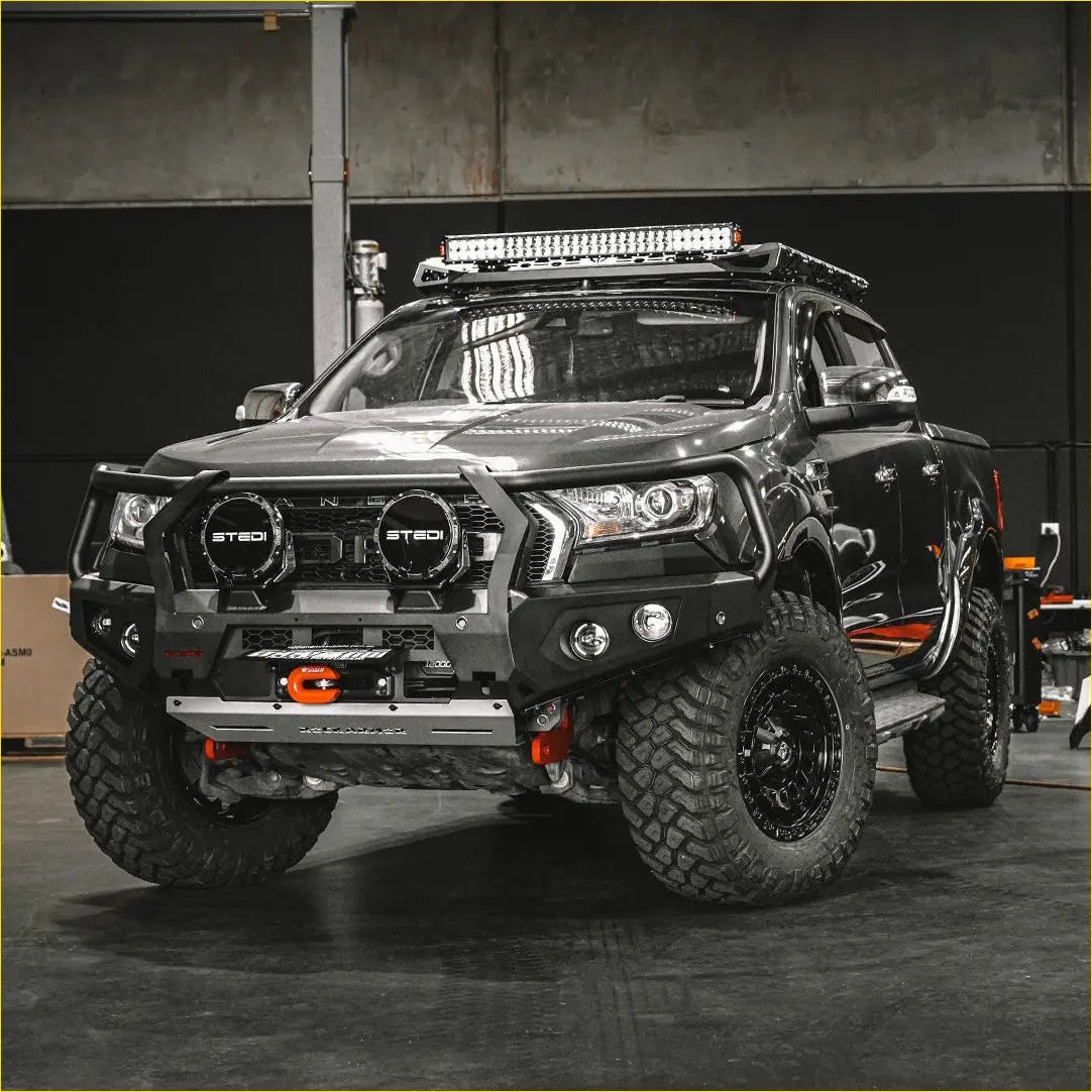 Black rugged ford ranger px2 with rockarmor gt steel hoop bullbar featuring heavy-duty bumper and led light bar