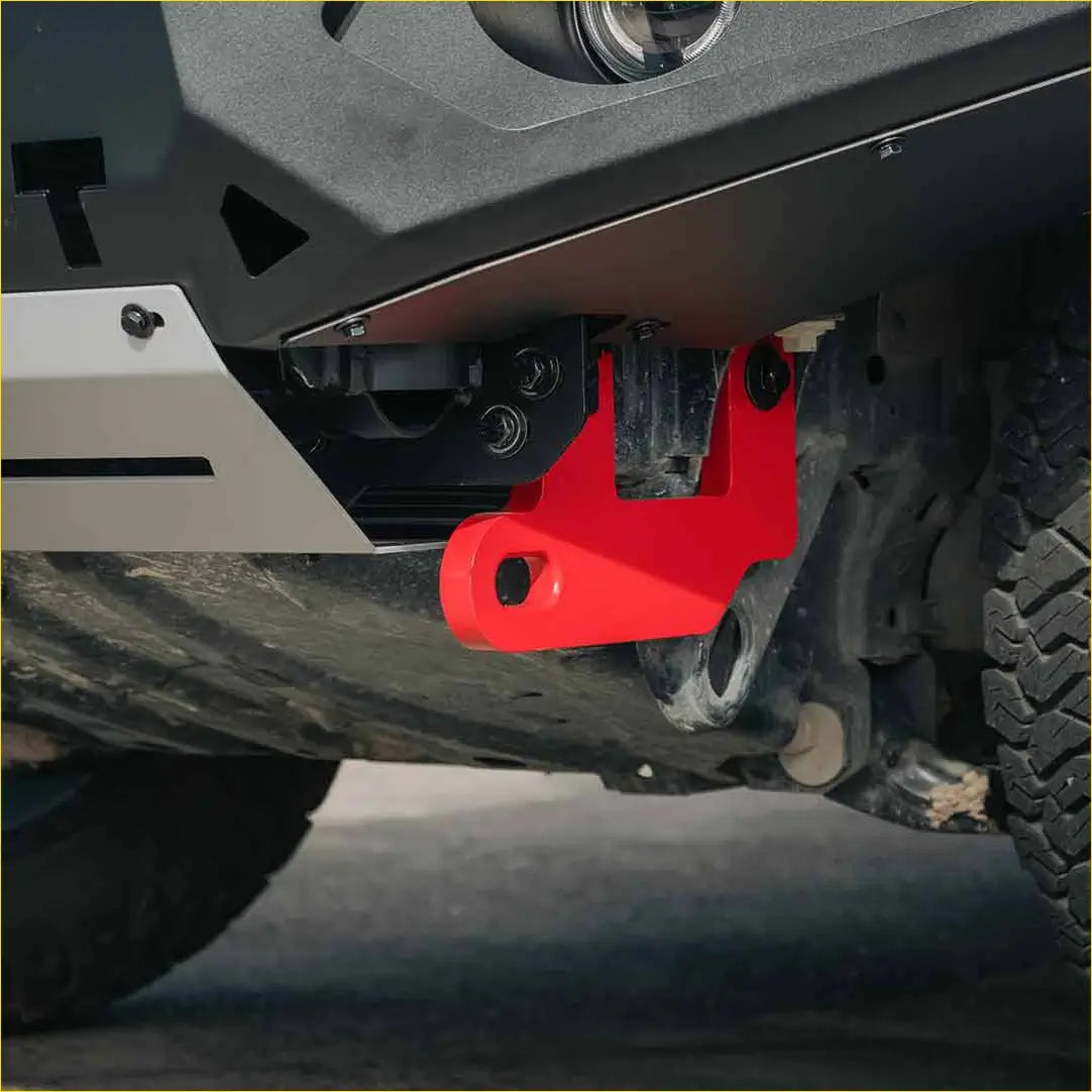 Bright red angular metal tow hook mounted under the rugged steel rockarmor gt bullbar on ford ranger px2 and 3