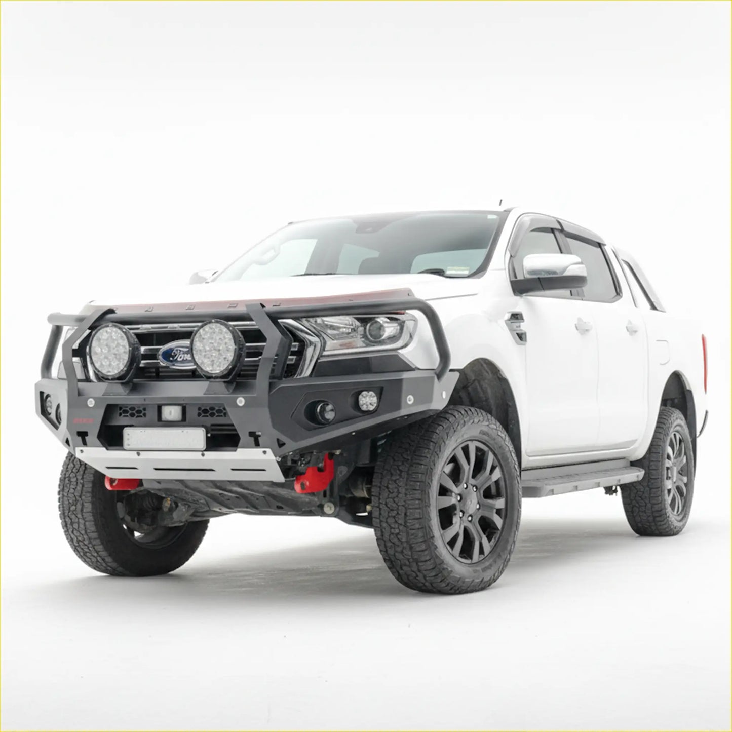 White ford ranger with black steel rockarmor GT hoop bullbar featuring integrated circular lights and red suspension parts