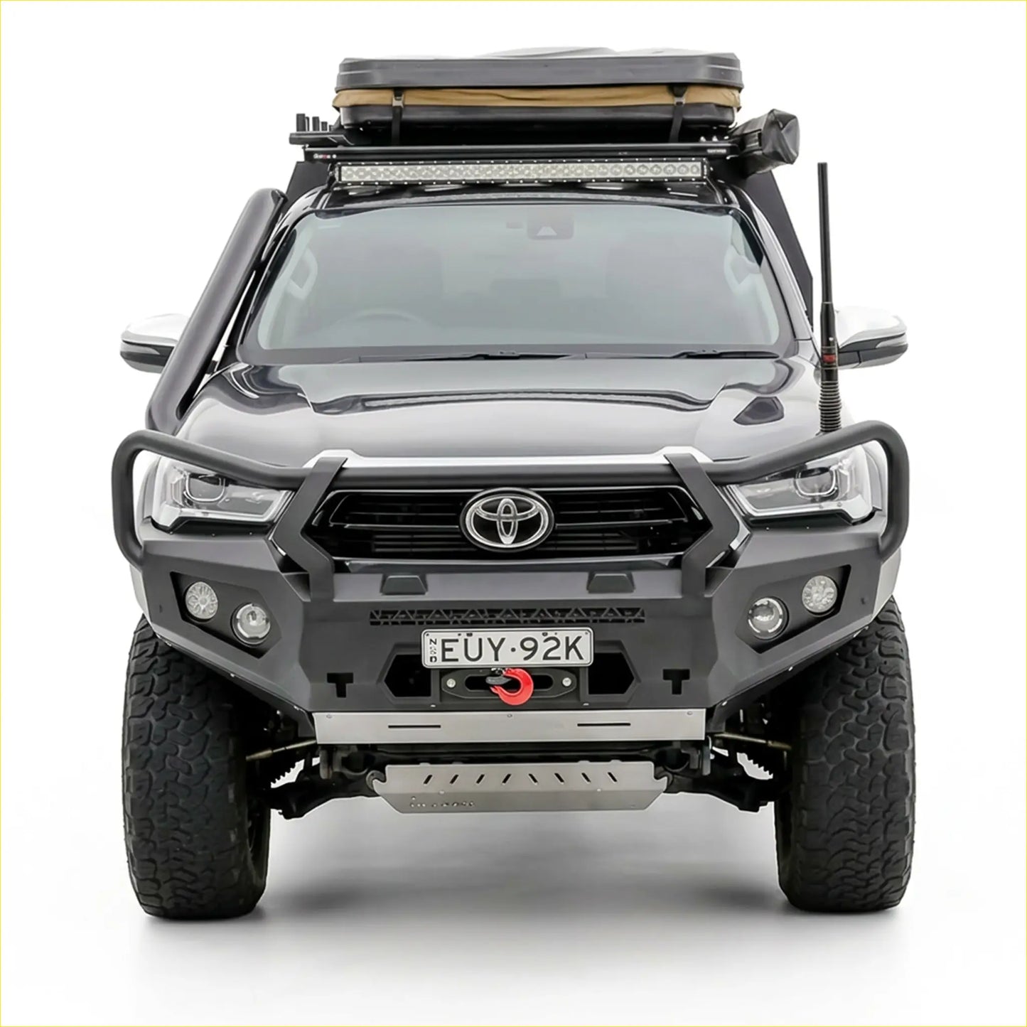 Black Toyota Hilux 2020-2025 with Rockarmor GT steel hoop bullbar and rugged off-road roof rack visible from the back