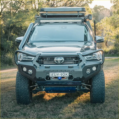 Dark gray toyota tacoma with rugged off-road features and roof rack featuring rockarmor gt steel hoop bullbar for hilux