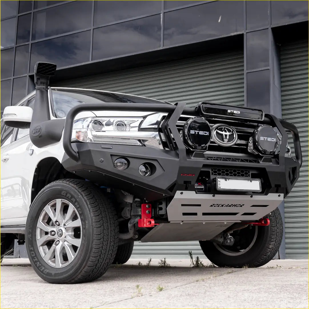 Black and silver steel rockarmor gt hoop bullbar with integrated lights mounted on a white toyota land cruiser