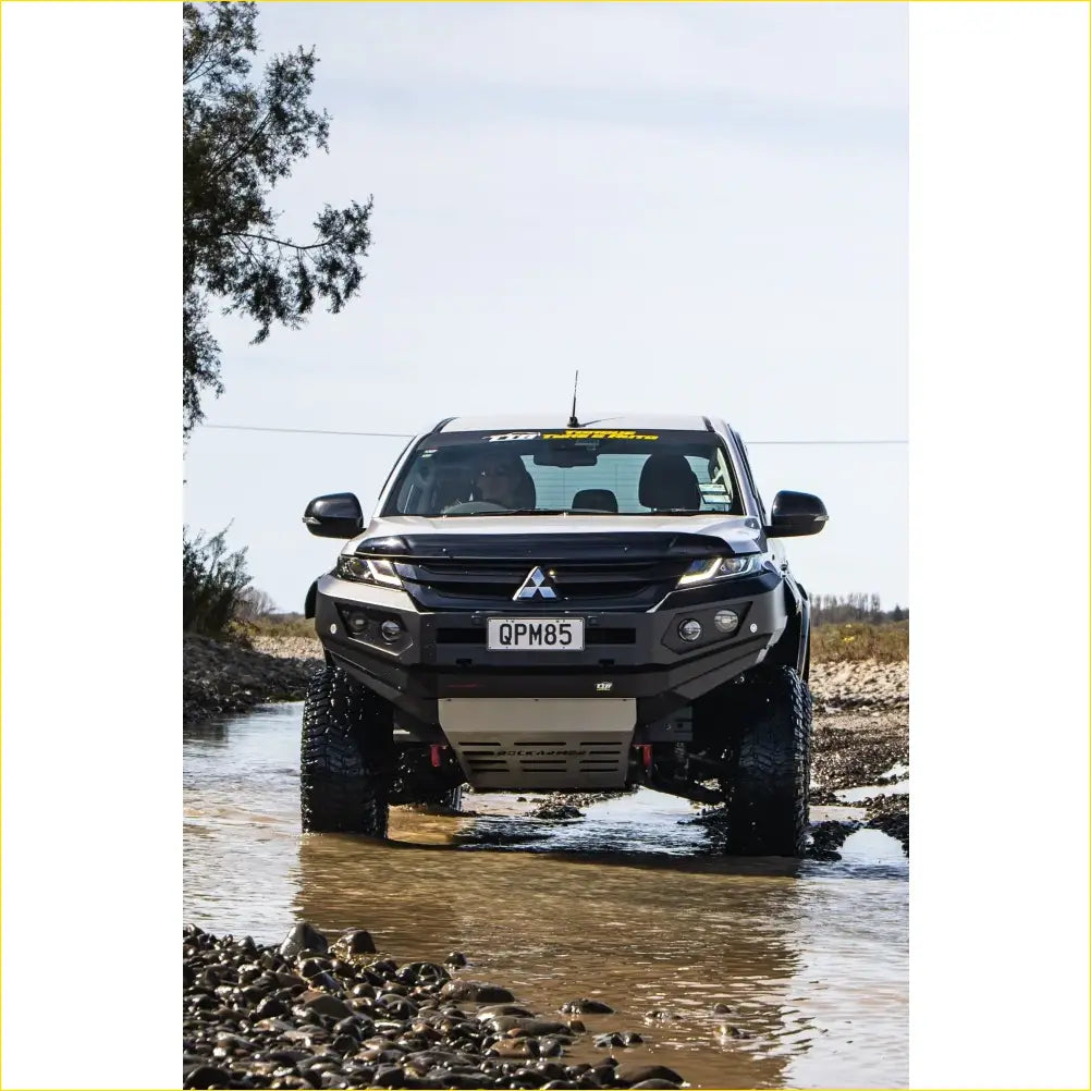 Black mitsubishi mr triton pickup with rockarmor gt steel hoopless bullbar combo pack and rugged off-road tires