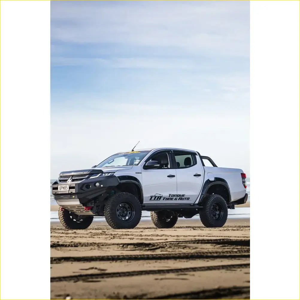 White mitsubishi triton with rockarmor gt steel hoopless bullbar combo pack featuring rugged front bumper and black tires