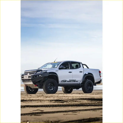 White mitsubishi triton with rockarmor gt steel hoopless bullbar combo pack featuring rugged front bumper and black tires
