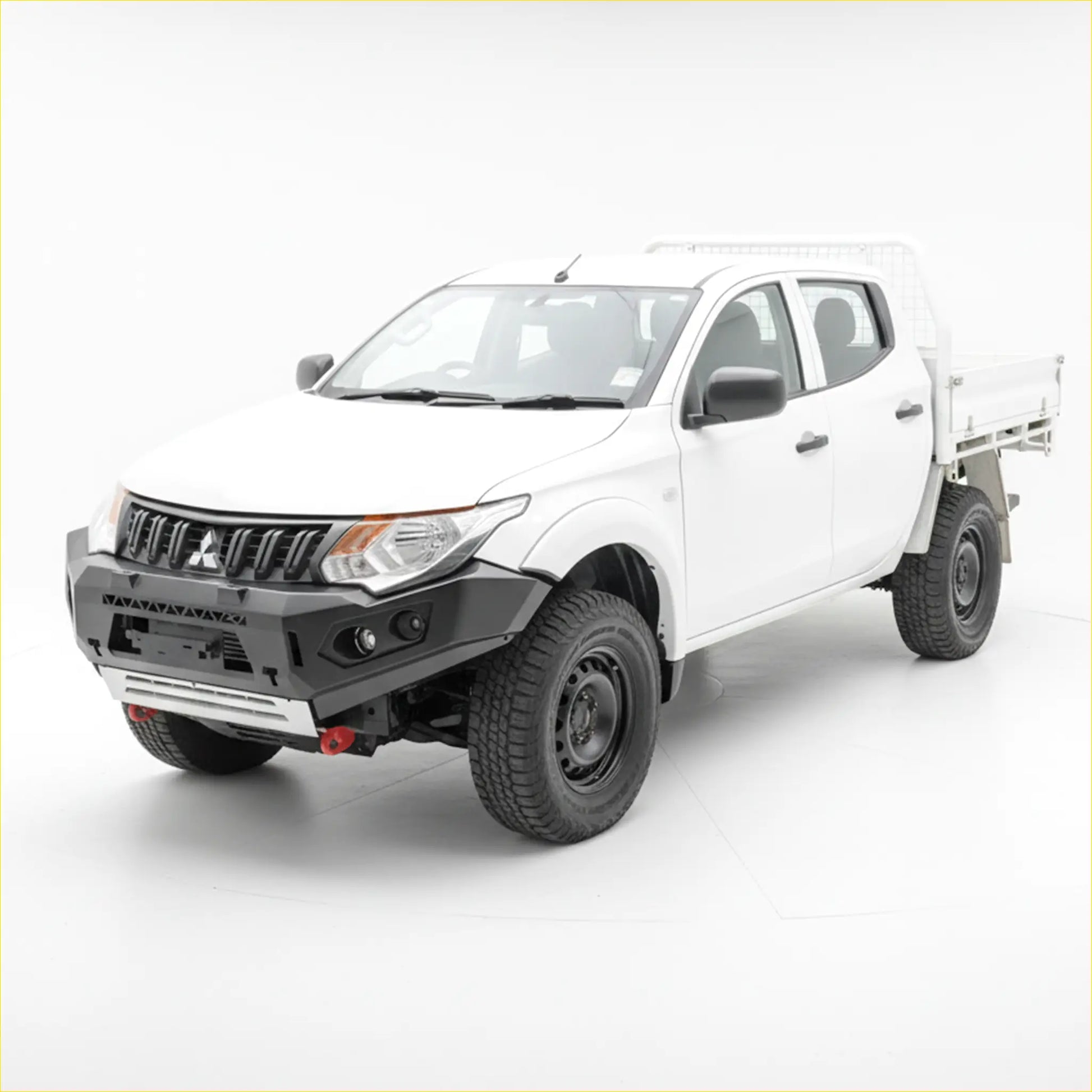 White Mitsubishi Triton with black steel Rockarmor GT hoopless bullbar and off-road tires on rugged terrain