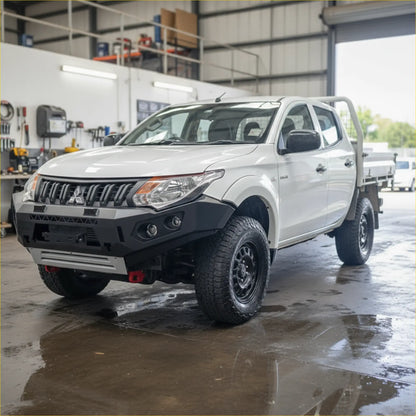 White mitsubishi triton with black off-road tires featuring rockarmor gt steel hoopless bullbar rugged front bumper