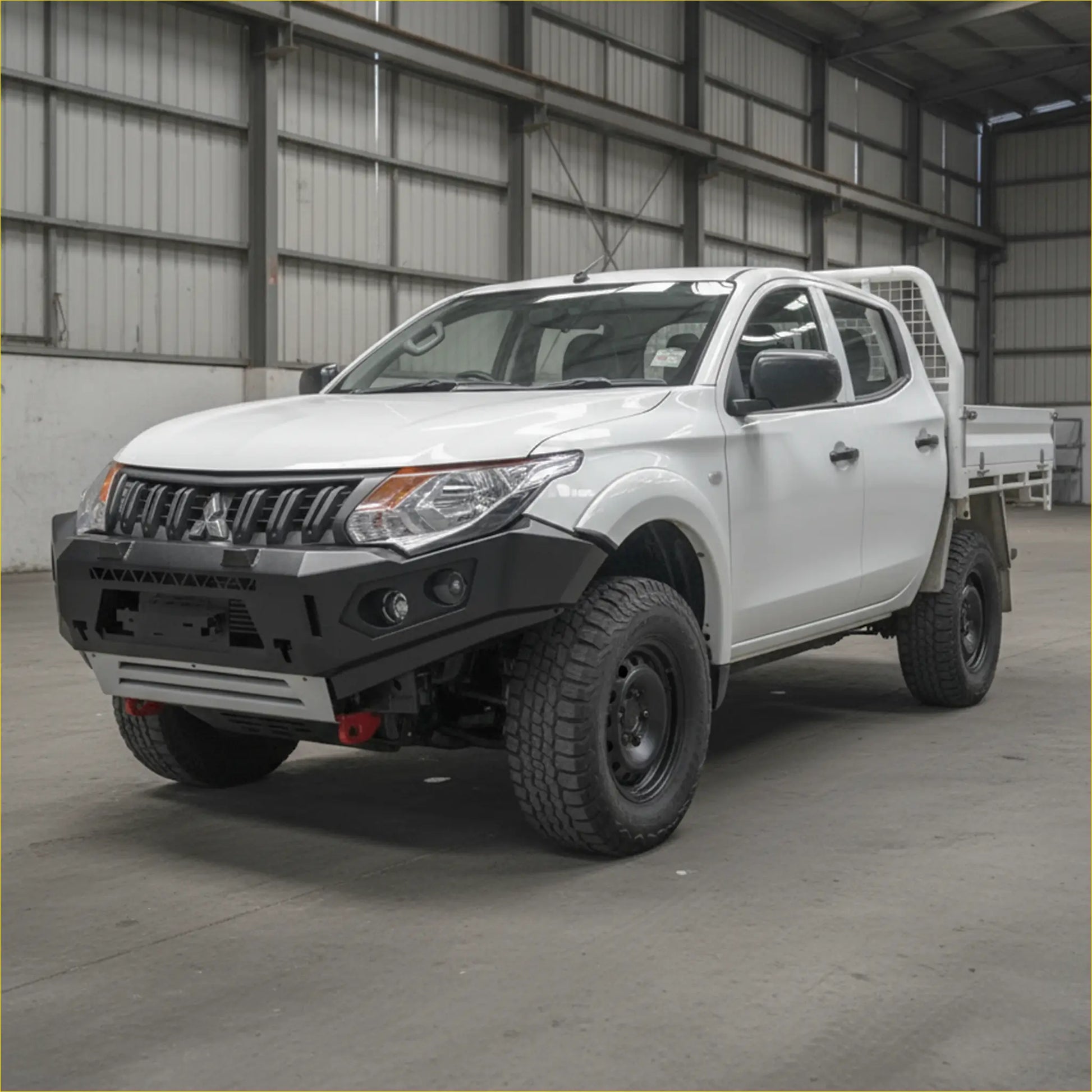 White mitsubishi mq triton pickup with black rockarmor gt steel hoopless bullbar and rugged off-road tires