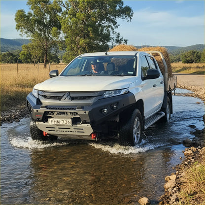 White mitsubishi triton with black rockarmor gt steel hoopless bullbar carrying hay in the bed