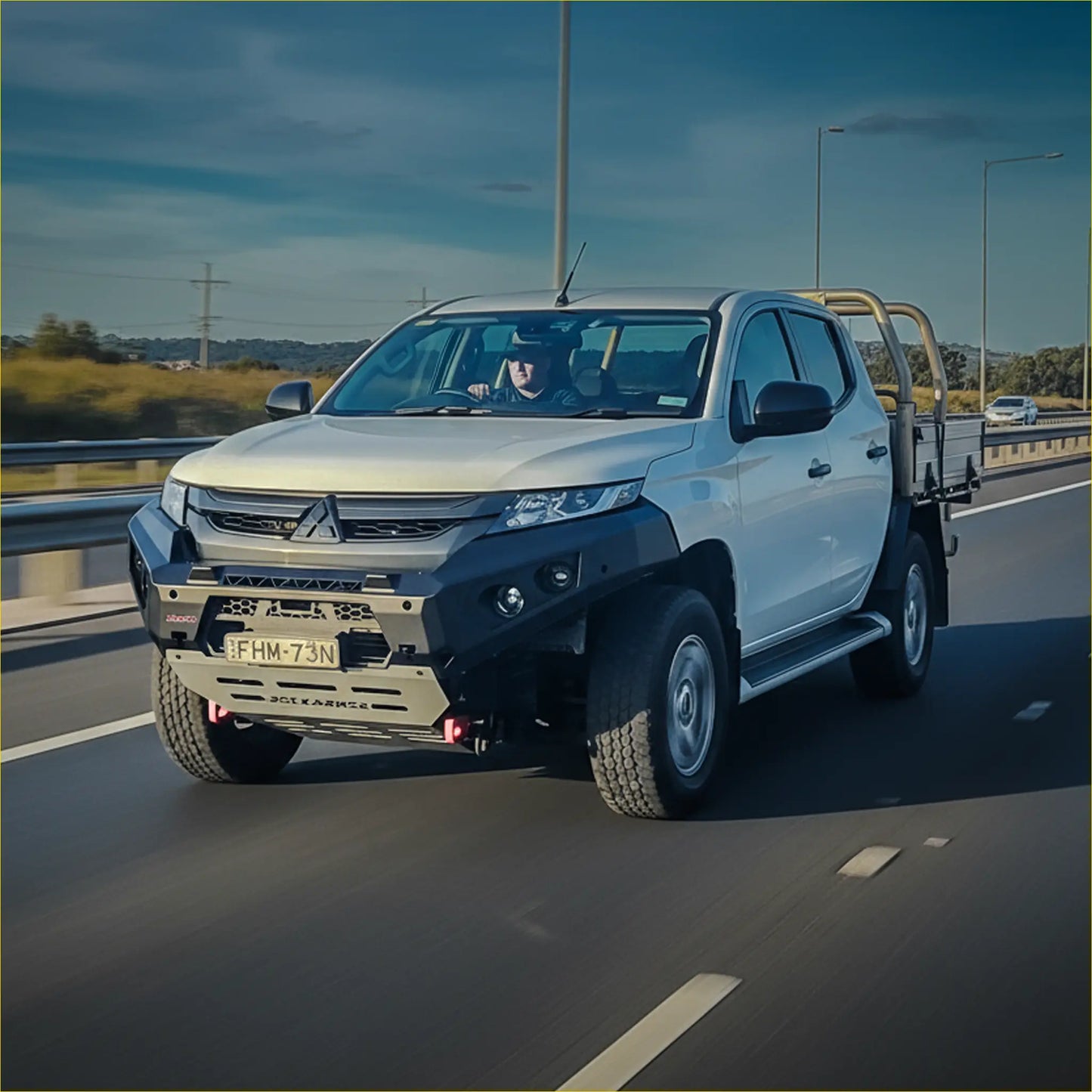 White mitsubishi triton with black steel rockarmor gt hoopless bullbar and yellow roll bars front view