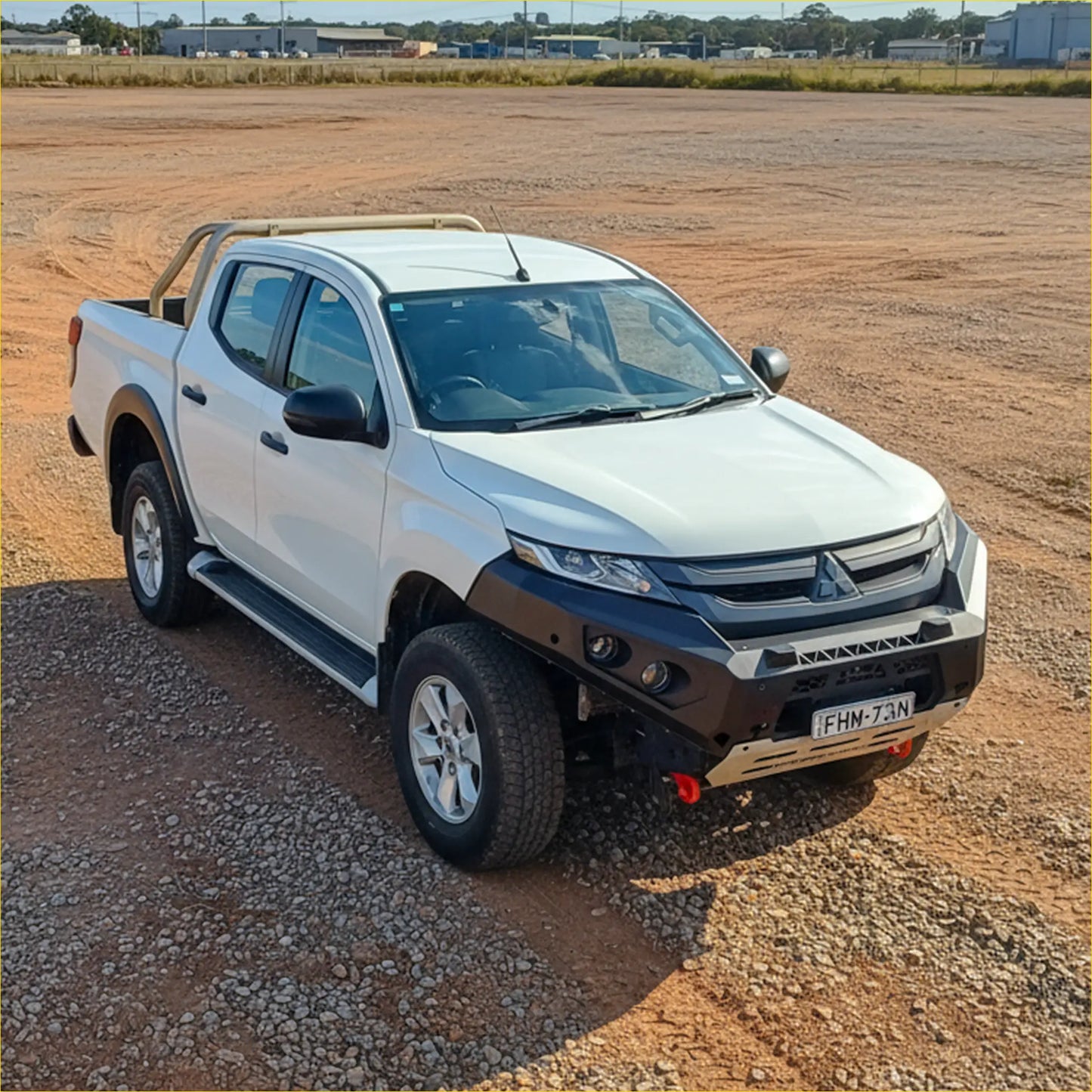 White mitsubishi triton pickup with black steel rockarmor gt hoopless bullbar front bumper and side steps