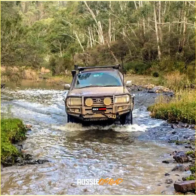 Brown toyota land cruiser with rugged off-road features and rockarmor premium bullbar combo pack front bumper