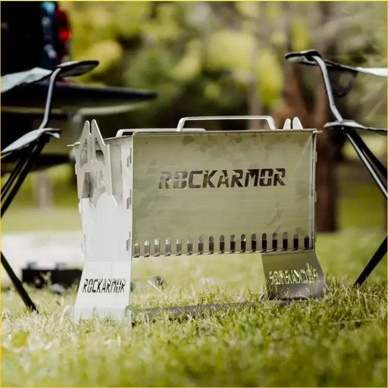 A sleek metallic rockarmor premium camp fire pit and bbq grille with engraved branding perfect for 4wd and offroad use