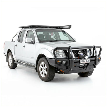 Black rugged steel front bumper with integrated winch and grille guard on white nissan navara d40 2005-2015