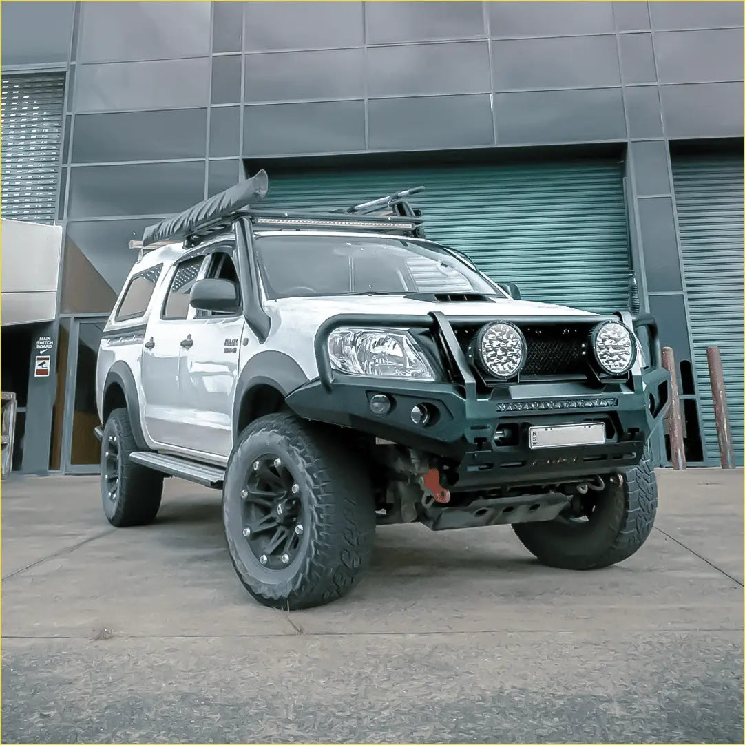 Silver toyota hilux n70 with black off-road accessories and rockarmor premium steel bullbar front grille protector