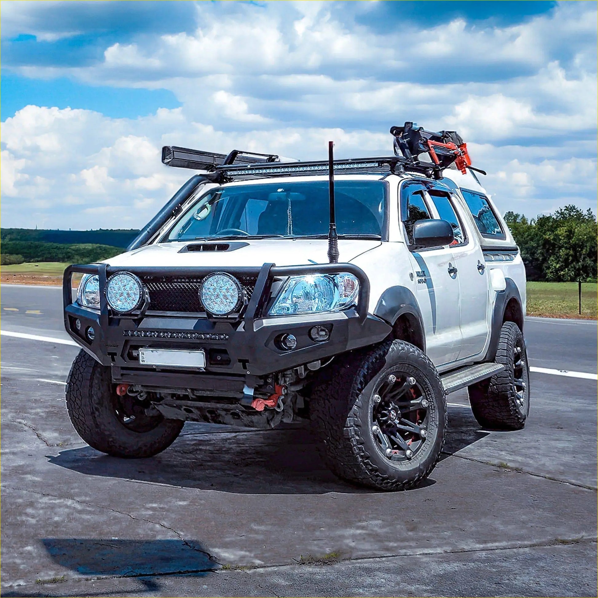 White toyota hilux pickup with black off-road accessories featuring rockarmor premium steel bullbar for n70 2005-2011 model