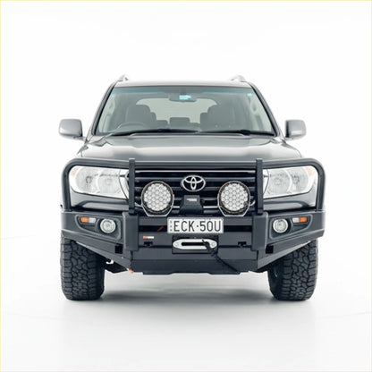 Black toyota land cruiser with rockarmor premium steel bullbar featuring rugged tires and two circular led lights