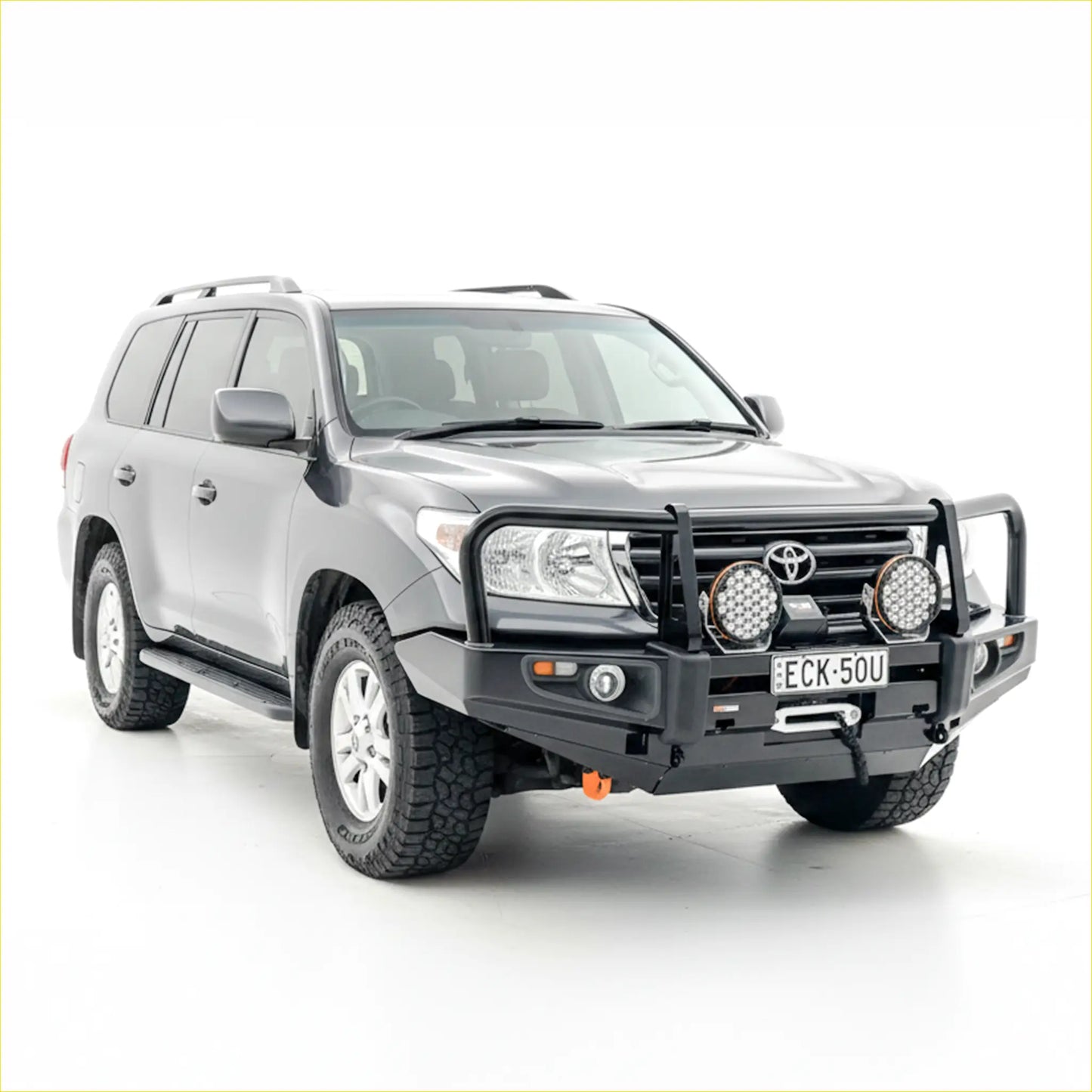 Silver toyota land cruiser with rockarmor premium steel black bullbar and auxiliary lights on the front