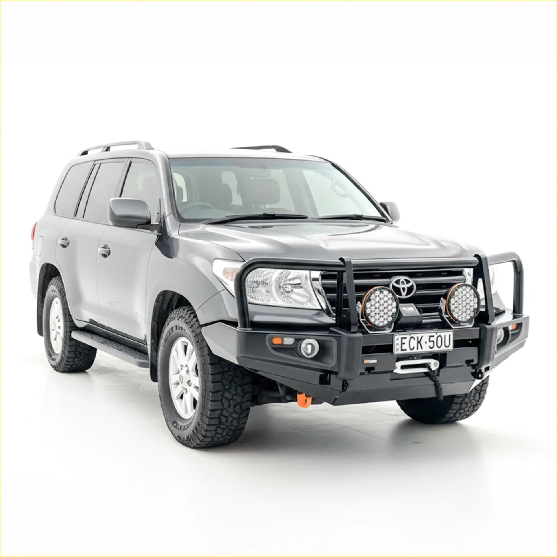 Silver toyota land cruiser with rockarmor premium steel black bullbar and auxiliary lights on the front