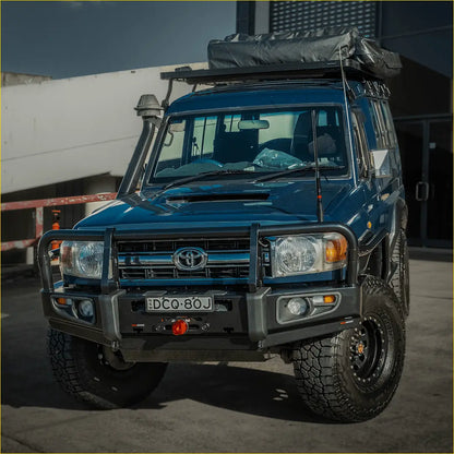 Deep blue toyota land cruiser with rockarmor premium steel bullbar rugged off-road tires and roof rack gear