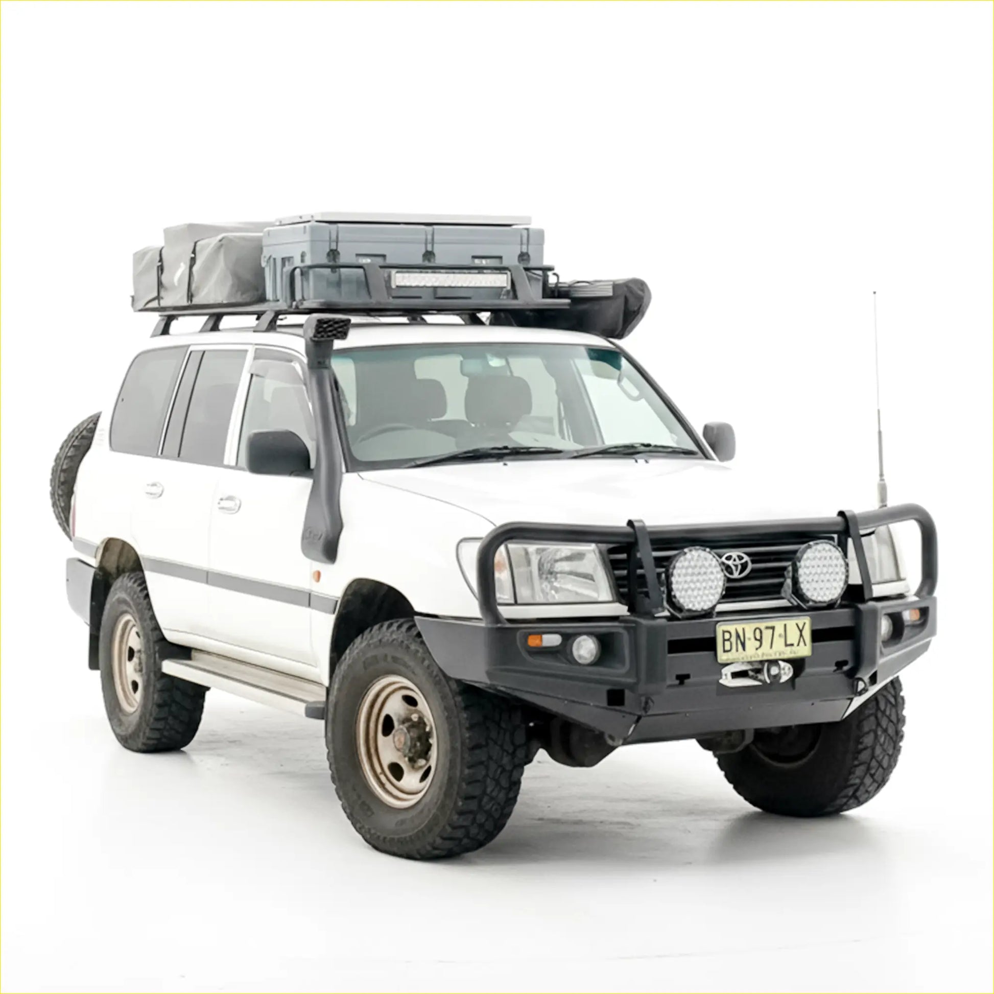 White toyota land cruiser 70 with black rockarmor premium steel bullbar and roof rack gear on front side