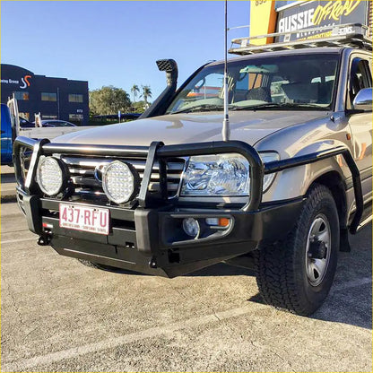 Silver metallic toyota land cruiser with black rockarmor steel bullbar and dual circular led lights on front bumper