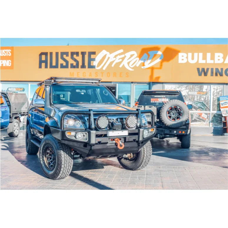 Modified off-road vehicle with Rockarmor premium steel bull bar and fog lights installed
