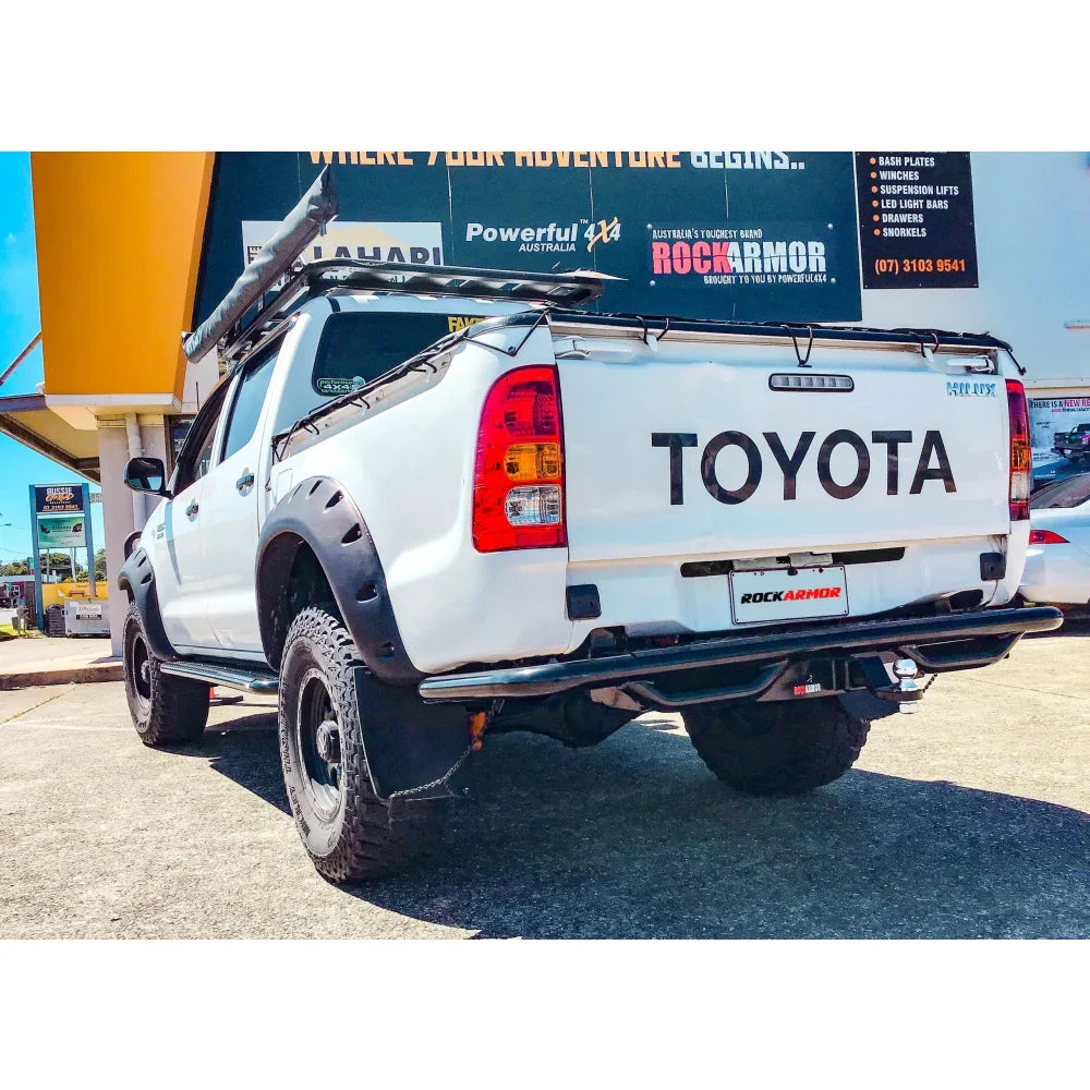 White Toyota Hilux pickup truck with Rockarmor rear step tow bar and steel rear step tow