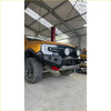 Black rugged front bumper with led lights and red tow hooks on yellow ford ranger from rockarmor rock pack
