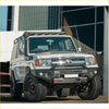 Silver toyota land cruiser 70 with black off-road tires and gt hoopless bullbar from rockarmor rock pack