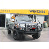 Black toyota hilux 2011-15 with premium rockarmor rock pack bullbar and rock sliders featuring orange accents