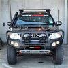 Black toyota land cruiser with rugged rockarmor rock pack featuring gt hoop bullbar and rock sliders for off-road use