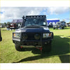 Black armored off-road toyota landcruiser 76 78 79 with rugged gt hoop bullbar roof rack and rock sliders