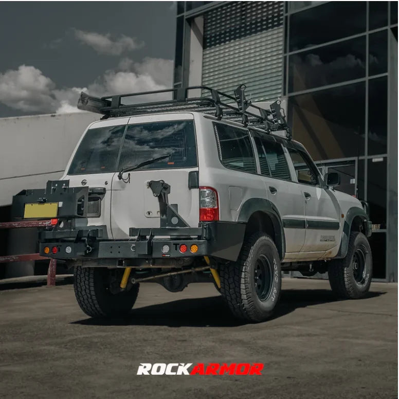 White off-road vehicle with roof rack featuring Rockarmor steel dual wheel carrier for Nissan Patrol Y61 with spare wheel, fitting video available