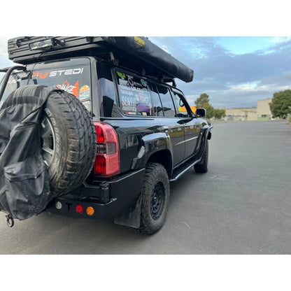 Black off-road vehicle with roof tent showcasing Rockarmor steel dual wheel carrier for Nissan Patrol Y61 Gu4 2004-2016 models and spare wheel fitting video
