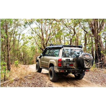 Tan off-road vehicle with Rockarmor Steel Dual Wheel Carrier for Nissan Patrol Y61