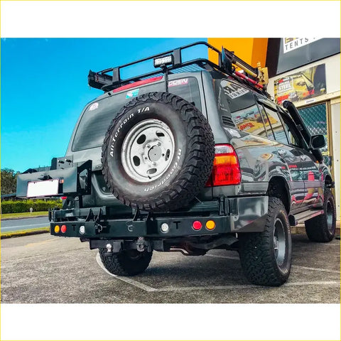 Black matte rockarmor steel dual wheel carrier mounted on rear of 4wd toyota landcruiser fj105 offroad ute