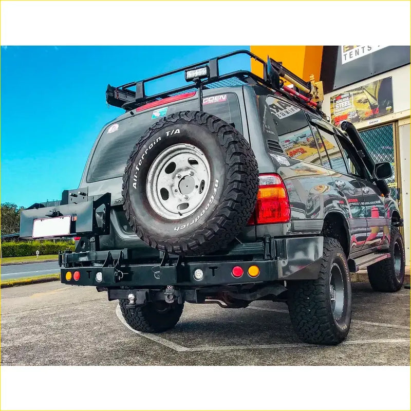 Black matte rockarmor steel dual wheel carrier mounted on rear of 4wd toyota landcruiser fj105 offroad ute