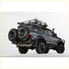 Black rugged 4wd suv with rockarmor steel dual wheel carrier and offroad tires for toyota landcruiser fj80 back side