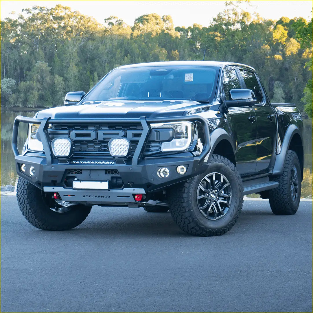 Black ford ranger raptor with rockarmor steel gt hoop bull bar rugged front bumper and off-road tires