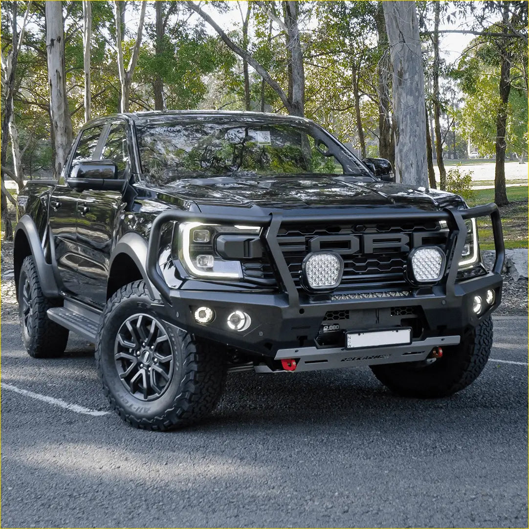 Black ford ranger raptor with rockarmor steel gt hoop bull bar featuring rugged off-road design and bold grille