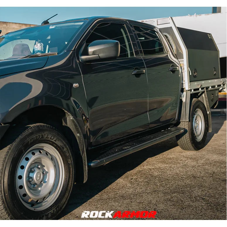 Black pickup truck with tray featuring Rockarmor Steel Rock Sliders for Isuzu Dmax 08/20+