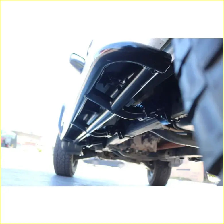 Black metal undercarriage guard with sleek angular design on rockarmor steel rockslider side steps for mitsubishi triton ml mn