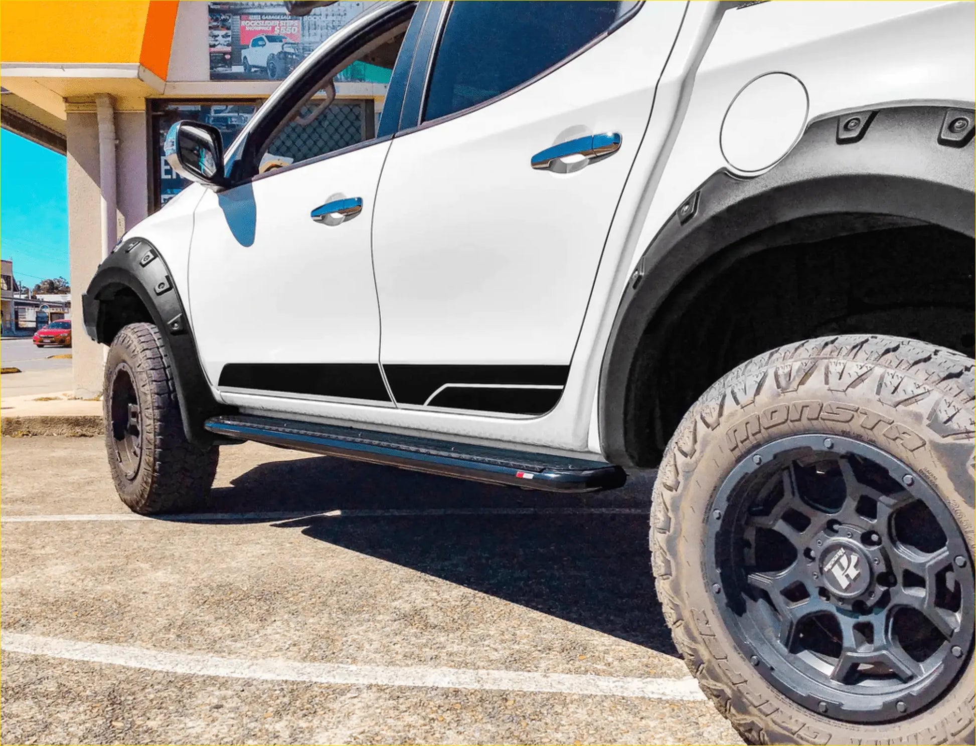 White pickup truck with black steel rockarmor rockslider side steps suited for mitsubishi triton ml mn viewed from side